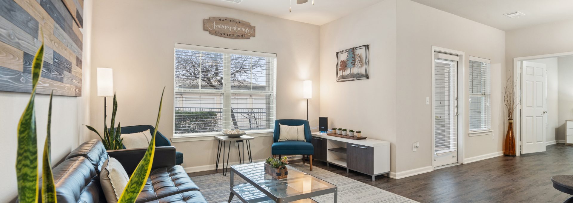 a living room with a ceiling fan and hardwood floors at The Creekside at Kenneys Fort